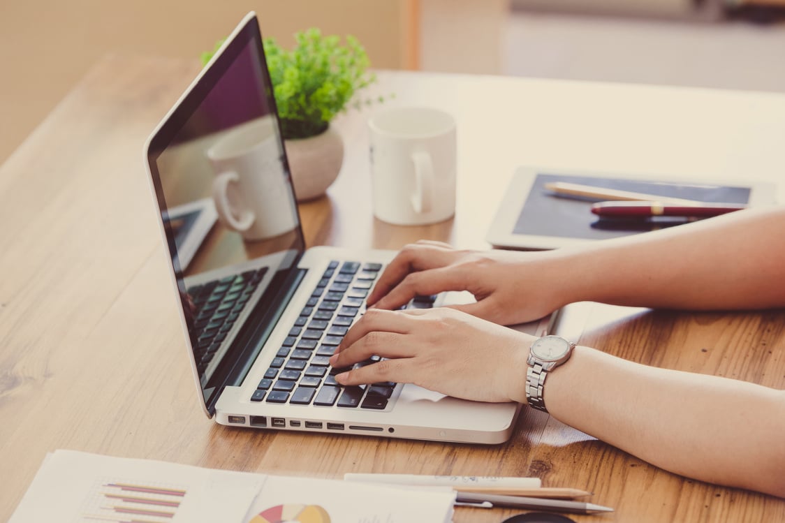 Person Writing on Laptop 